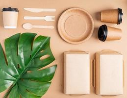 Eco friendly disposable tableware on brown background photo