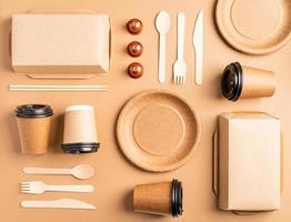Eco friendly disposable tableware on brown background photo