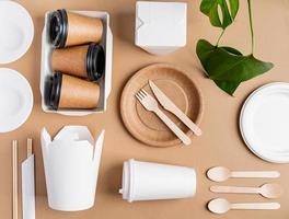 Eco friendly disposable tableware on brown background photo