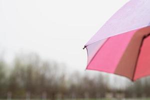 Close up of colorful umbrella part with raindrops photo