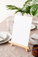 Menu or stand for booklet on restaurant table with tropical bouquet photo