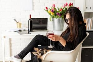 Business woman drinking wine, celebrating holidays at home photo
