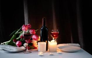 Romantic candlelight dinner for two lovers, dark background photo
