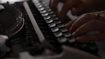 Hands of female office worker typing on retro typewriter on the desk. video