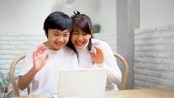 Mother and son talk using laptop for communication and happy time video