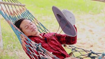 man sleeping in a hammock video