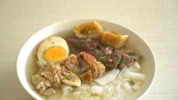 rice flour or boiled Chinese pasta with pork in brown soup video