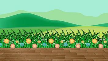 Flower field and green grass with mountain backdrop vector