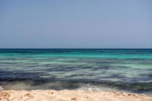 Wonderful turquoise water of Migjorn beach in Formentera in Spain. photo