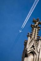 Cologne Cathedral Tower and airplane vapor trails in Germany photo
