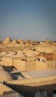 Downtown rooftops wind towers and landscape view of Yazd city old town in Iran photo