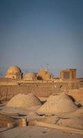 Downtown rooftops wind towers and landscape view of Yazd city old town in Iran photo