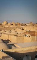 Downtown rooftops wind towers and landscape view of Yazd city old town in Iran photo