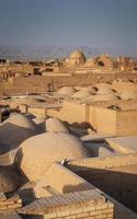 Downtown rooftops wind towers and landscape view of Yazd city old town in Iran photo