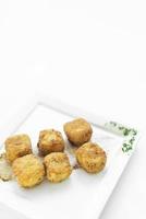 Fried mashed potato square croquettes simple vegetarian side dish on white plate photo