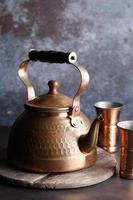 Ancient Moroccan tea pot on a wooden tray photo