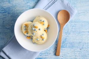 Vanilla ice cream on a blue background with a blank space for a text, vanilla ice cream in white ceramic cup photo