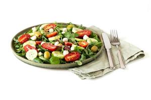 Arugula, tomato, cucumber, mozzarella and olive salad photo