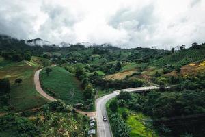 Mountain road in rainy and foggy day photo