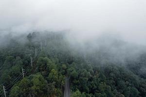 Mountain road in rainy and foggy day photo