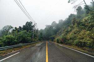 Mountain road in rainy and foggy day photo