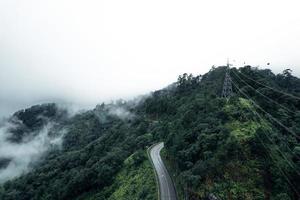 Mountain road in rainy and foggy day photo