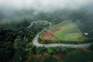 Mountain road in rainy and foggy day photo