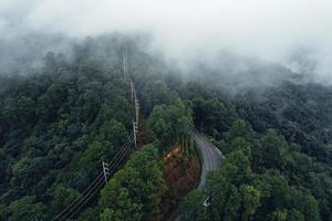 Mountain road in rainy and foggy day photo