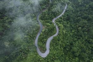 Mountain road in rainy and foggy day photo