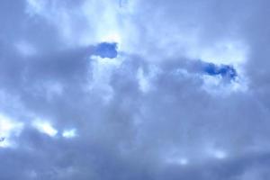 dramatic high deep blue sky with fluffy clouds photo