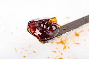 Cannabis concentrate with dab stick, high THC wax. photo
