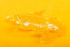 Golden cannabis wax oil with high THC concentrate. photo