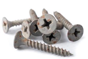 Small rusty screws for metal isolated on white background close up. photo