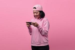 Beautiful Asian woman playing video game on smartphone photo