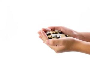 Human hand holding a lot of coins on white background photo
