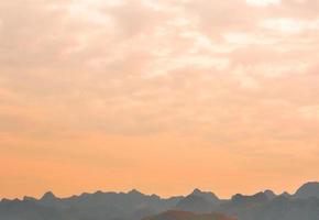 Bright color sky over the mountain in evening time photo