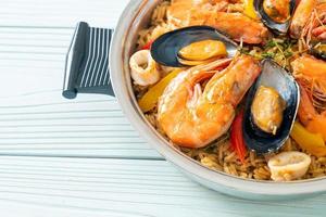 Seafood Paella with prawns, clams, mussels on saffron rice photo