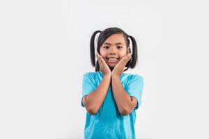 Portrait of Funny little girl acting in studio shot. photo