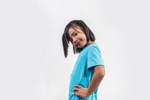 Portrait of Funny little girl acting in studio shot. photo