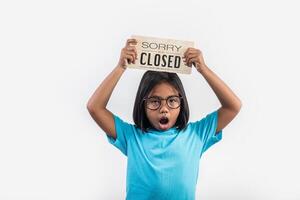 Little girl hand holding wood sign closed photo