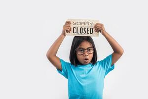 Little girl hand holding wood sign closed. photo