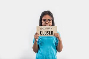 Little girl hand holding wood sign closed photo