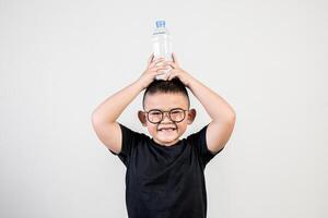 Funny boy with water bottle in studio shot photo