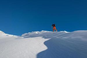 Ski touring uphill on the italian alps photo