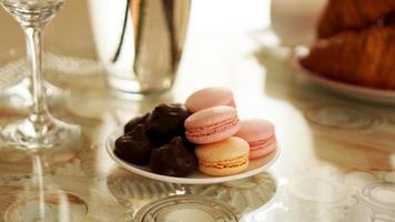 Macaroons on a glass table. Sweets for breakfast. Sunny photo