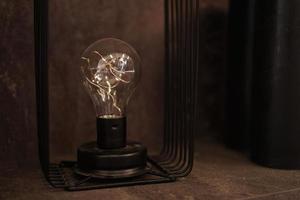 Edison lighbulb on a stand. One old decorative lamp for loft photo