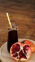 Ripe pomegranates with juice on wooden background. photo