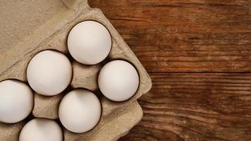 White eggs on wooden background photo