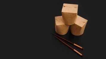 Brown paper cardboard food container on black background photo