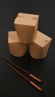 Brown paper cardboard food container on black background photo